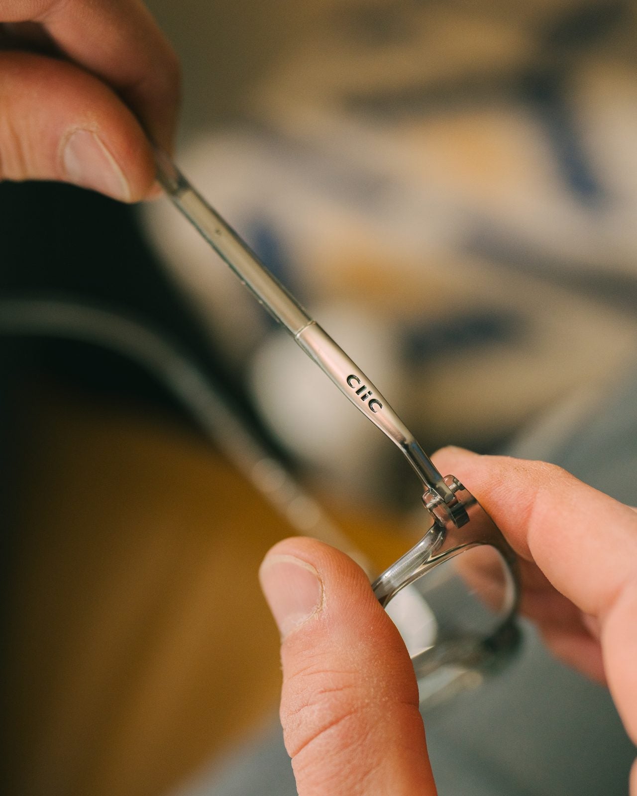 Hands holding the two magnetic halves of a CliC frame apart
