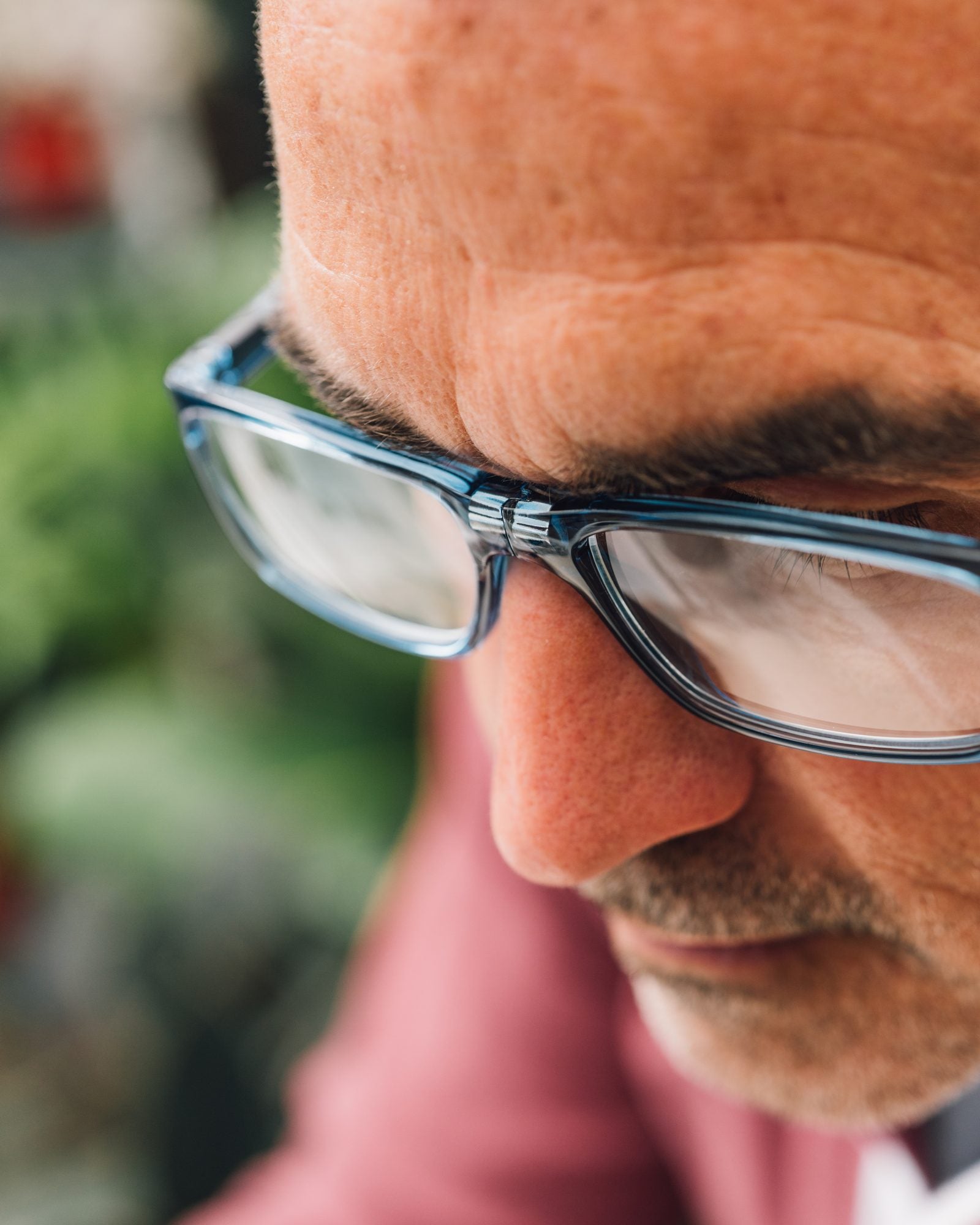 Close view of a man looking down through blue CliC readers