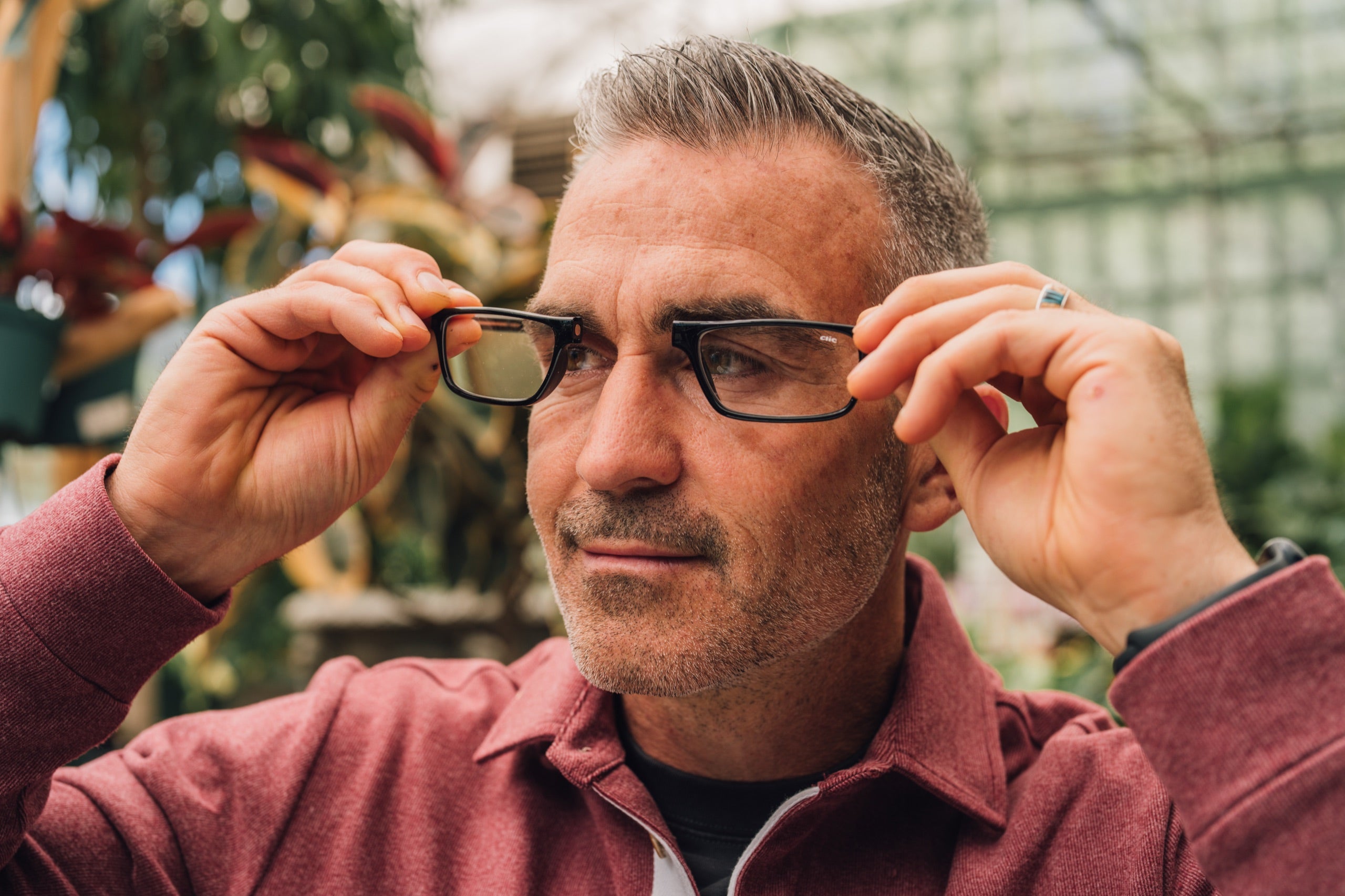 Gardener putting on CliC readers in the greenhouse